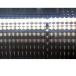 003-LED-LIGTH-big - Diamond Line Close-up of a bright LED light strip, with multiple white bulbs glowing and reflecting on a glossy surface below.